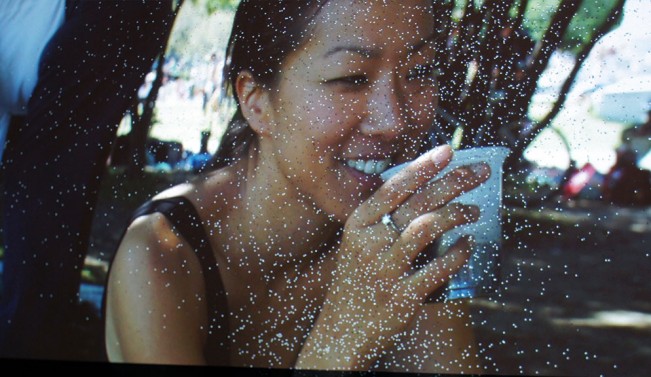 A damaged HD video projector presents a photograph of a young woman on a 270×150 cm screen.
